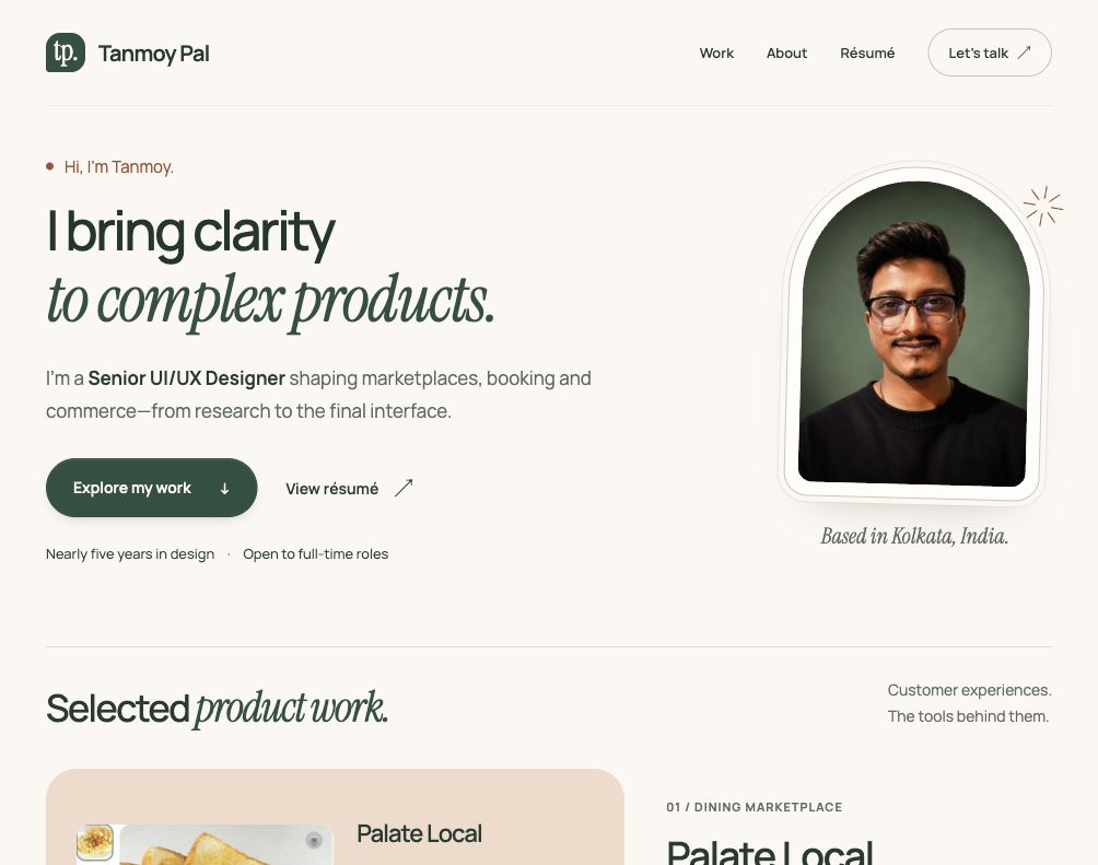 Refined portfolio homepage with an italic headline, finely framed portrait, original tp. badge and the beginning of selected work